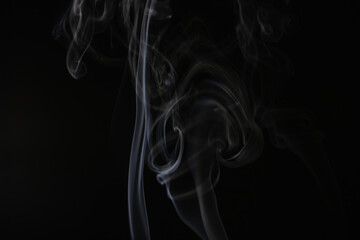 White flowing smoke on black background