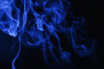 Blue flowing smoke on black background