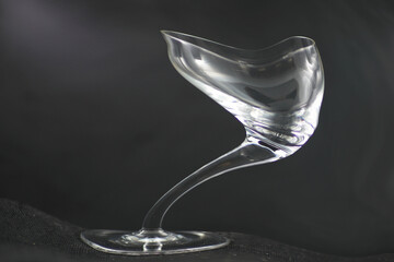Deformed champagne glass on a grey background