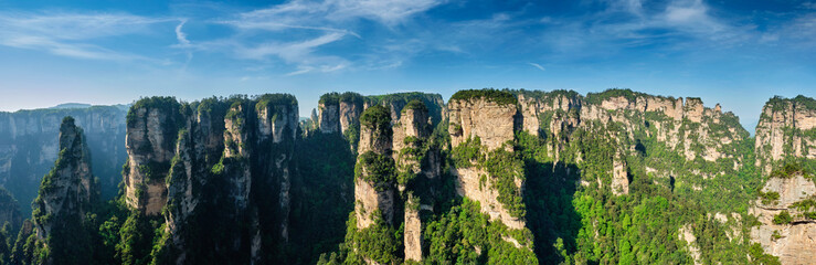 Fototapeta na wymiar Panorama of famous tourist attraction of China Avatar mountains - Zhangjiajie stone pillars cliff mountains on sunset at Wulingyuan, Hunan, China