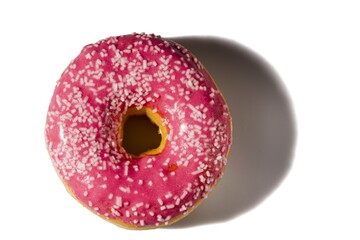 Fototapeta na wymiar Close up view of donut sprinkled with white glaze isolated on white background. Food and drink concept.