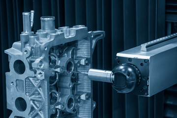 The multi-axis CMM machine checking the aluminum cylinder head parts . The quality control of automotive parts with multi axis CMM machine.