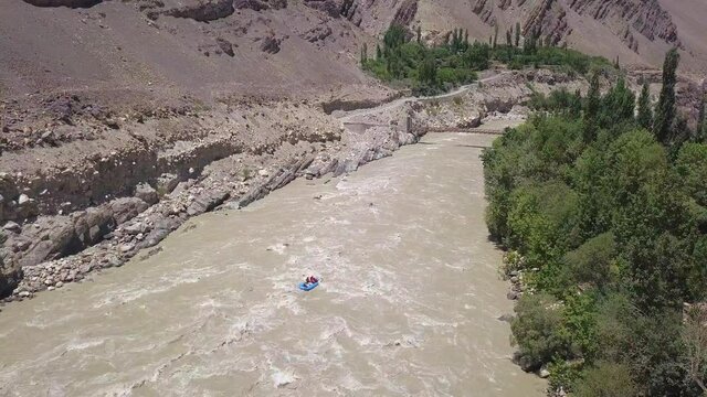 Water Rafting In Zanskar River With Lush Poplar Trees By The Ladakh Range On Summer In Leh Ladakh, India. - aerial drone shot