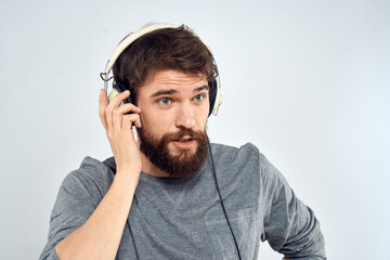 Man in headphones listens to music lifestyle leisure light background