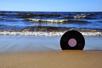 Vinyl record on the sand.