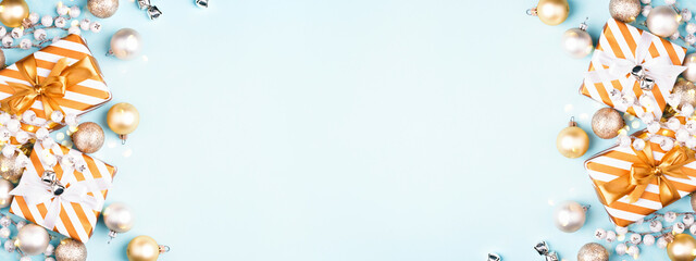 Banner with Christmas composition with gift boxes and golden decorations on blue background. Flat lay, greeting card.