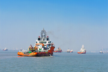 Fototapeta premium Beautiful orange boat standing in the middle of the ocean with blue sky