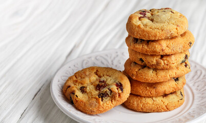 Freshly baked homemade Christmas cookies with cranberries, almonds and white chocolate. Delicious festive biscuit. Gingerbreads. Selective focus, copy space