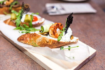 Fresh salad on bruschetta . Restaurant food concept