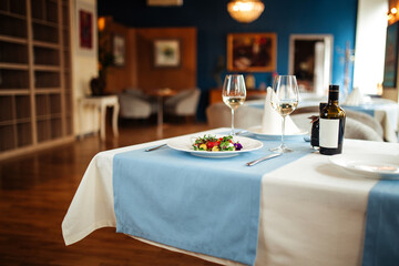 Restaurant table served with spanish tomato salad