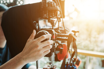Fototapeta na wymiar Hand focus puller or first assistant camera working in film shooting