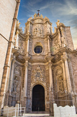 Fototapeta na wymiar Door of Los Hierros and baroque facade of the cathedral of Valencia, Spain