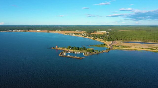 Aerial view towards the Keskuskari island, Kalajoen Hiekkasarkat beach in the background, sunny, summer evening, in Kalajoki, Pohjois-Pohjanmaa, Finland - Dolly, drone shot