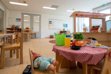 ARNHEM, NETHERLANDS - Aug 28, 2020: Children in kindergarten play with toys. Other toys stored in...