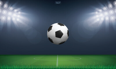 Soccer football ball and green grass of soccer field stadium background. Vector.