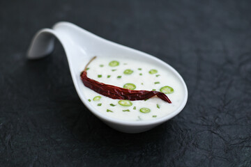 Fresh Vegetable Raita or curd Mumbai North India. Indian food yogurt dip with tomatoes and cilantro. side dish, dip or cooked salad for Biryani, fried rice, chapati, Masala Papad, Pulao, Pulav, Roti. 