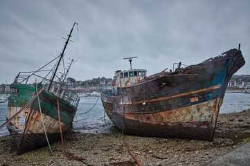 Fototapeta na wymiar Abandoned shipwrecks in a harbor in Brittany, France.