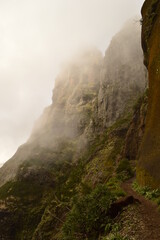 Climbing to the dramatic peak of Pico Ruivo mountain on the ridge of Madeira Island, Portugal