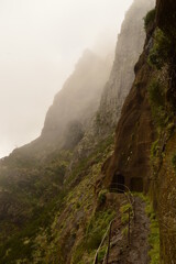 Climbing to the dramatic peak of Pico Ruivo mountain on the ridge of Madeira Island, Portugal