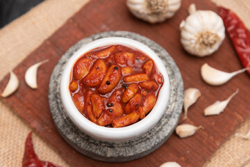 Home made sour hot and spicy garlic or Lehsun pickle,  Kerala South India made using red chilli and Indian spices. Its cloves are used for consumption raw or cooked or for medicinal purposes