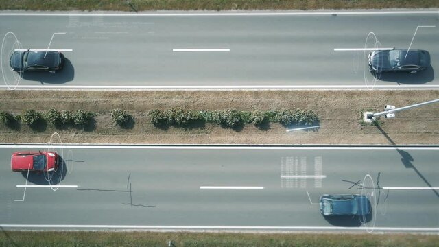 Road safety camera observes and scans passing cars. Digital traffic jam and traffic announcement. Slow motion - bird's eye view.