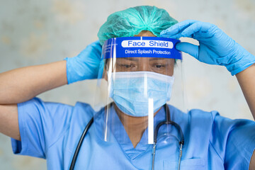 Asian doctor wearing face shield and PPE suit new normal to check patient protect safety infection...