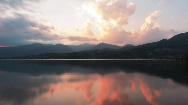 Timelapse of the Sun Setting on a Lake with Fiery Clouds