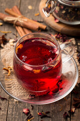 Cup of fresh red tea on wooden background