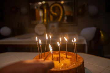 Lighting birthday candles on an Angel Food Cake