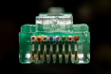 Macro cross section front angle view of RJ45 CAT6 shielded network data internet cable clear connector