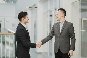meeting discussing new plans for the development of the site. confident stylish young, short haircut. businessmen managers working on laptop in a bright office.
