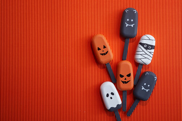 Set of ice cream with halloween character face on orange background. Halloween party background