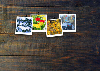 Fototapeta na wymiar Four photos of four seasons on dark wooden surface. Seasons on dark background