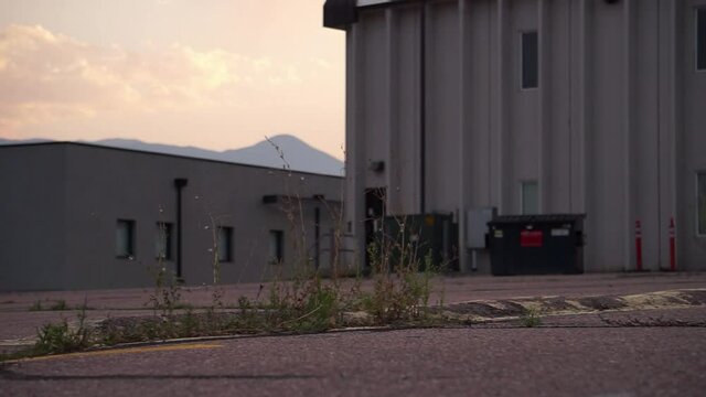 Young skateboarder does slo-mo ollie over speed bump in parking lot