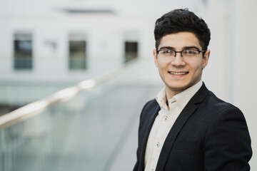 Fototapeta premium manager businessman with glasses looks at the camera, good mood. Caucasian appearance, stylish fashionable hairstyle, favorite work.