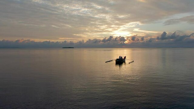 Drone Flies Over a Fishing Boat to The Sunset Horizon in Tawi-Tawi, Philippines Aerial