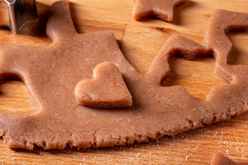 Cutting out pastry shapes for gingerbread Christmas cookies