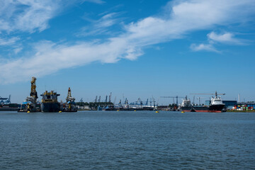 Fototapeta premium Harbor with large cranes and containers in Rotterdam, Holland