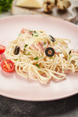 Carbonara for children. Tomatoes, noodles, bacon and olives