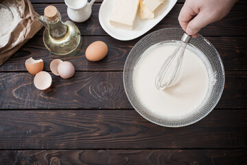 dough  and products for its preparation on  dark wooden background