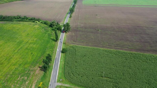 Straight 2 lane with cars and trucks driving back and forward