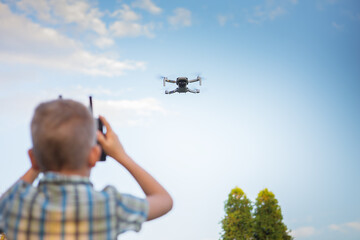 Kid flying drone. Boy operate drones