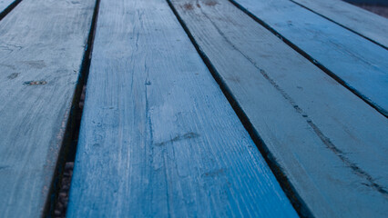 Rustic textured cafe table tops, planks of wood painted blue.