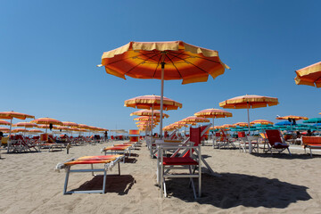 Summer beach landscape with umbrellas and beach chairs