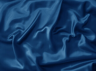 Fototapeta premium Shiny blue crumpled fabric. Wavy cloth background