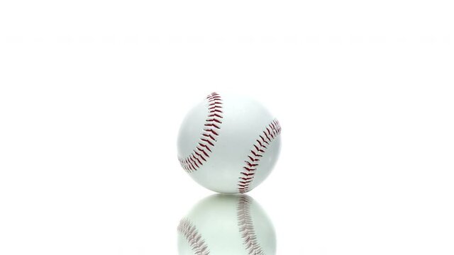 Baseball ball reflecting in glass table spinning rotating 360 isolated on white background. Beginning of sports career concept. exercise equipment.