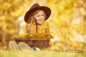 girl with basket of autumn leaves