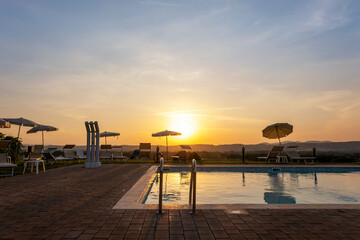 Outdoors sunset swimmingpool. Tropical resort hotel