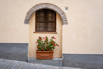 Fototapeta na wymiar Spello, Perugia, Umbria, Italy. Typical alley with potted plants and flowers