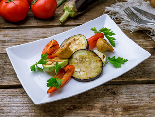 grilled vegetables on a plate on old wooden table